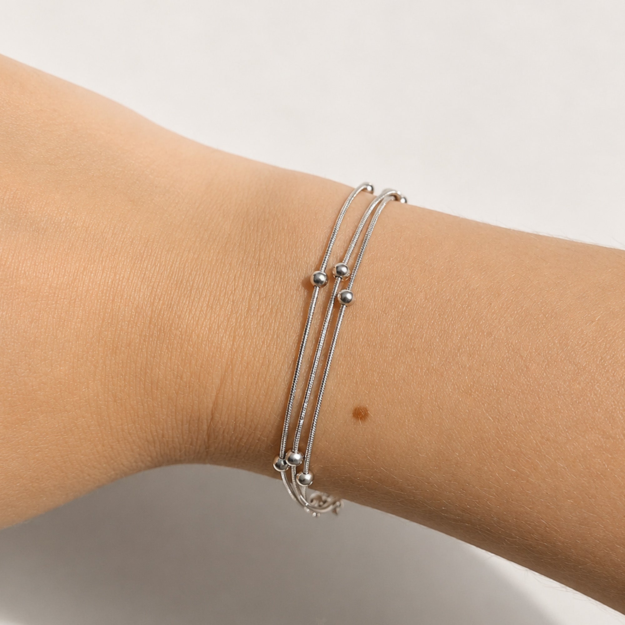 Sylva Three Layer Bracelet silver on model wrist — Tamola Jewellery