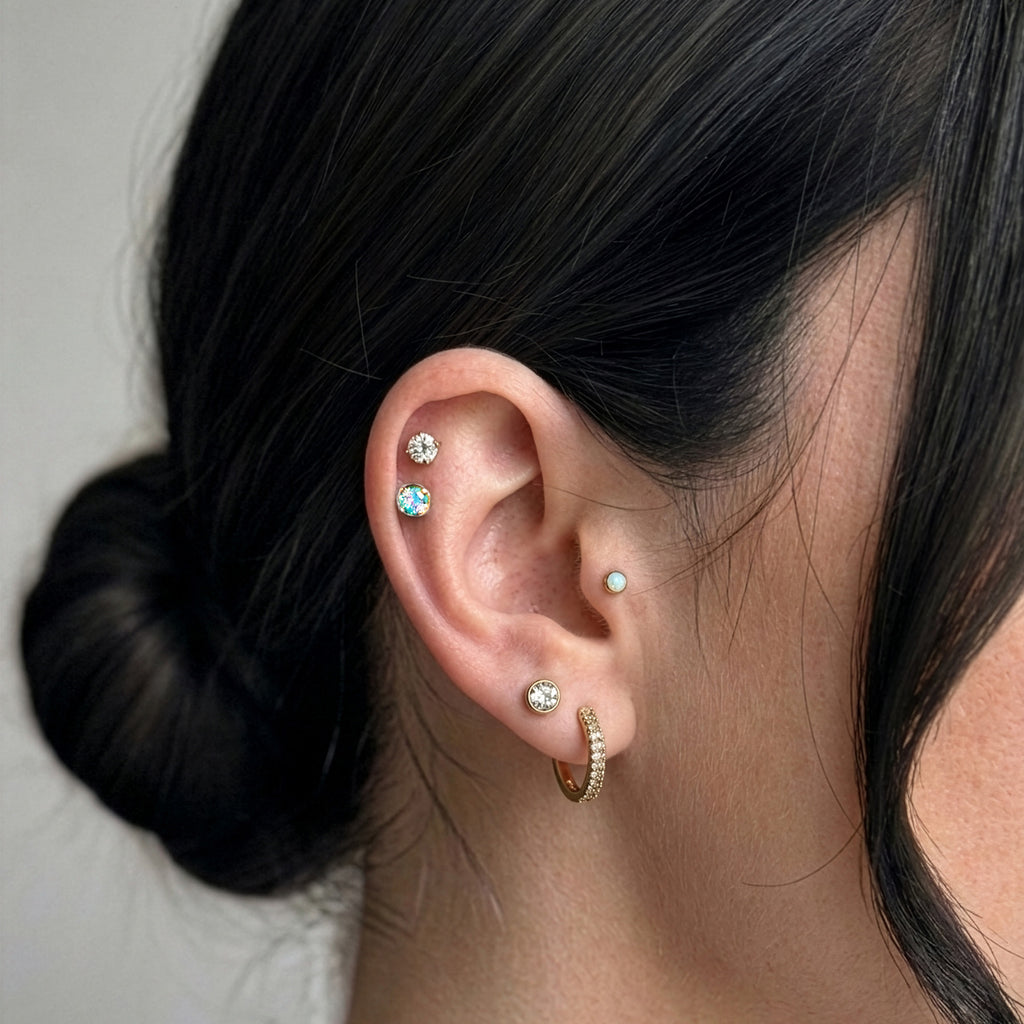 Lumiere Piercing Stack gold on model ear — Tamola Jewellery