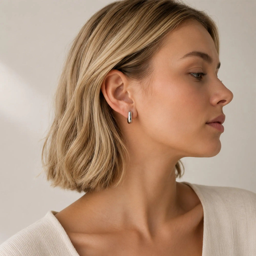 Solène Huggie Earrings silver sculptural close-up stainless steel — Tamola Jewellery